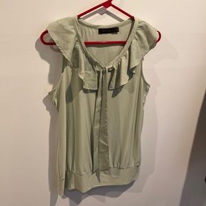 The limited green sleeveless ruffled blouse